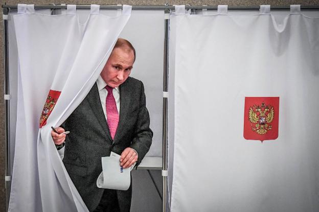 Vladímir Putin, ayer, en el momento de ejercer su derecho al voto en un colegio de Moscú. :: r. c./