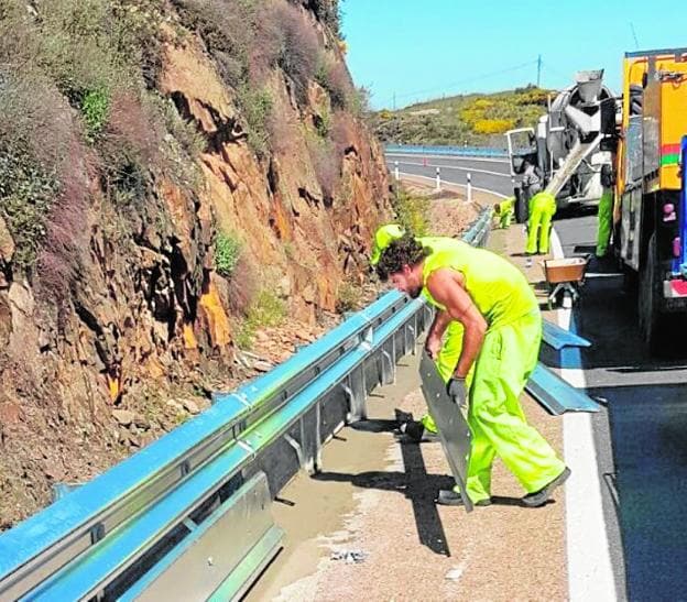 Los supervisores de carreteras montan las nuevas barreras de seguridad. 